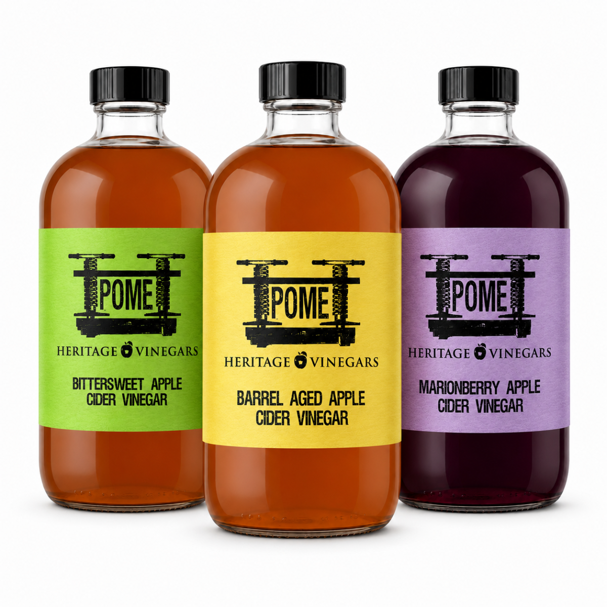 The three POME vinegars side by side: Bittersweet with a green label, Barrel Aged with a yellow label, and Marionberry with a lavender label.