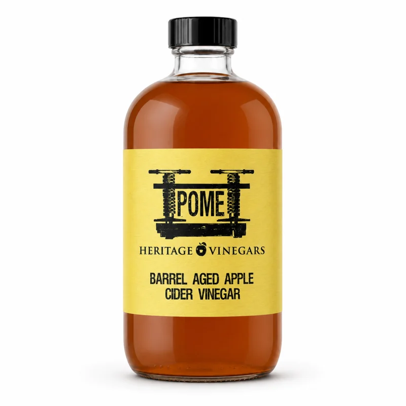 POME Barrel Aged Apple Cider Vinegar in a clear Boston round bottle with a yellow label.